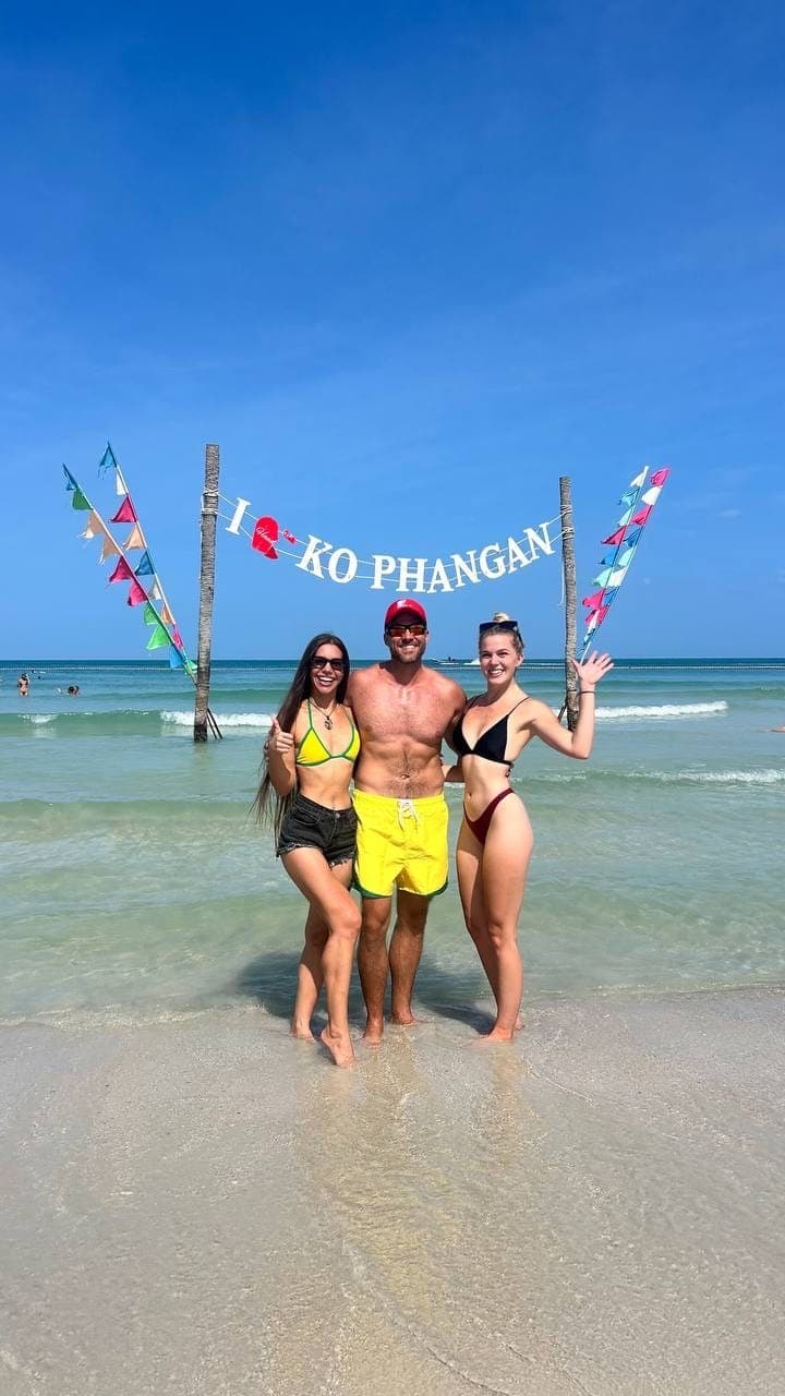 Friends at the I love Ko Phangan sign on the beach